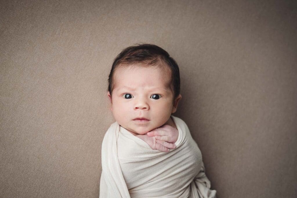 Newborn Photography Singapore | Meadow Lullabies Stern baby face staring at photographer