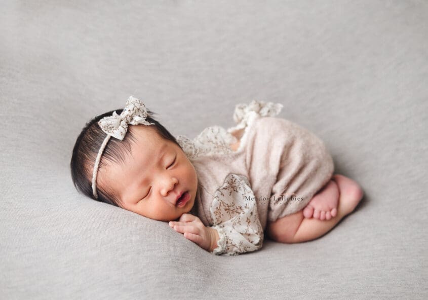 newborn photography bum up pose on plain grey backdrop