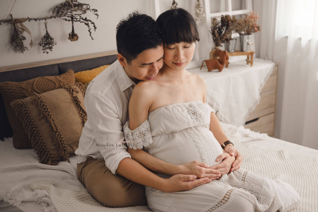 Maternity photoshoot in home setting rustic decor on bed