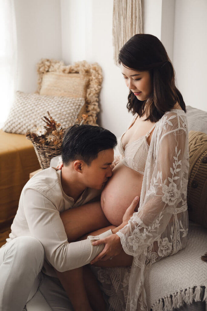Maternity photography Singapore hubby kissing wife's tummy